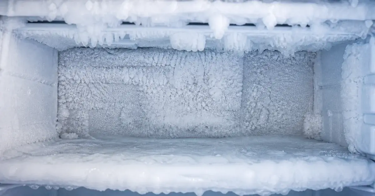 Freezer compartment with heavy frost and ice build-up before repair